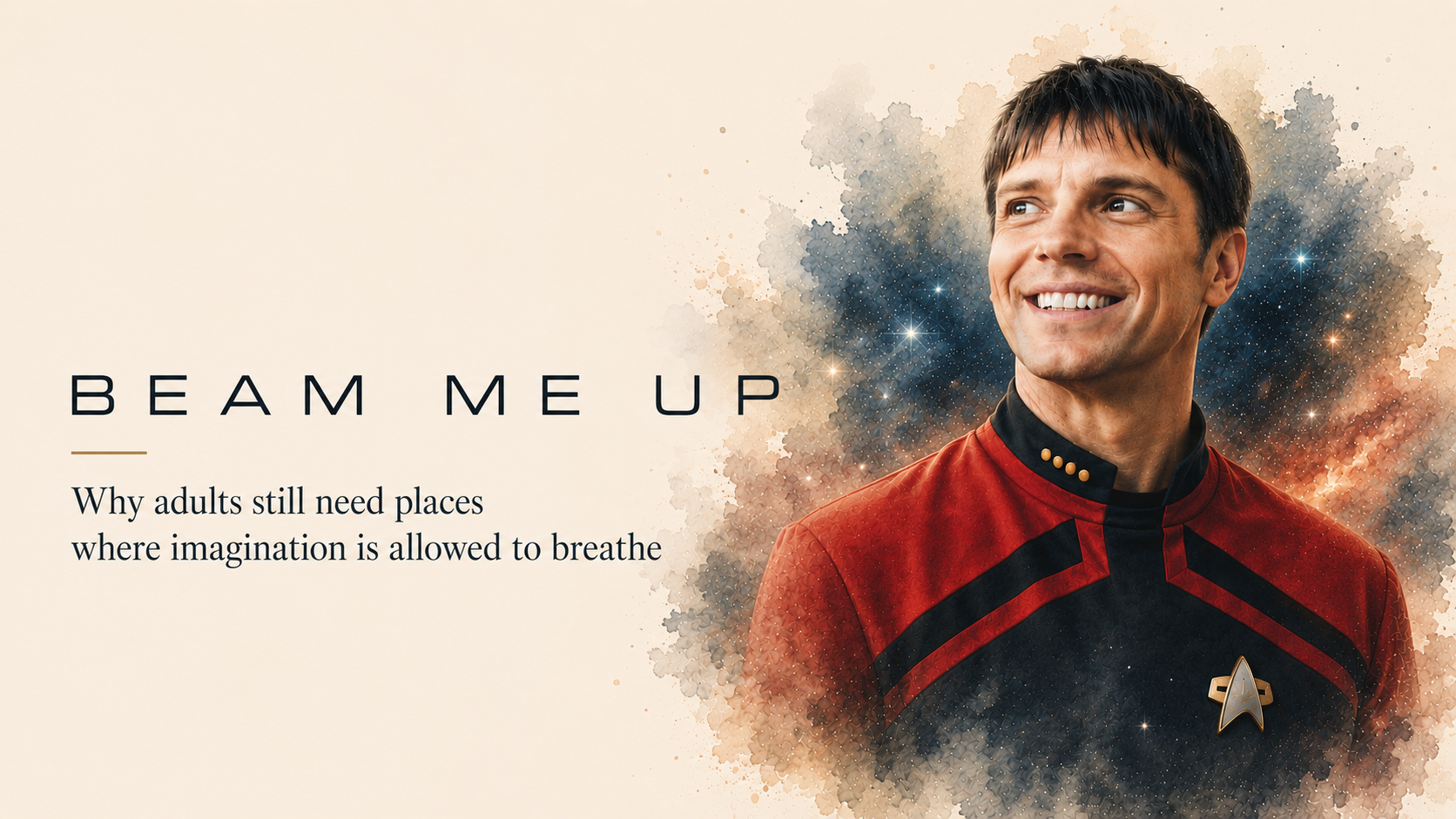 A smiling man in a red science-fiction uniform against a soft cosmic backdrop.