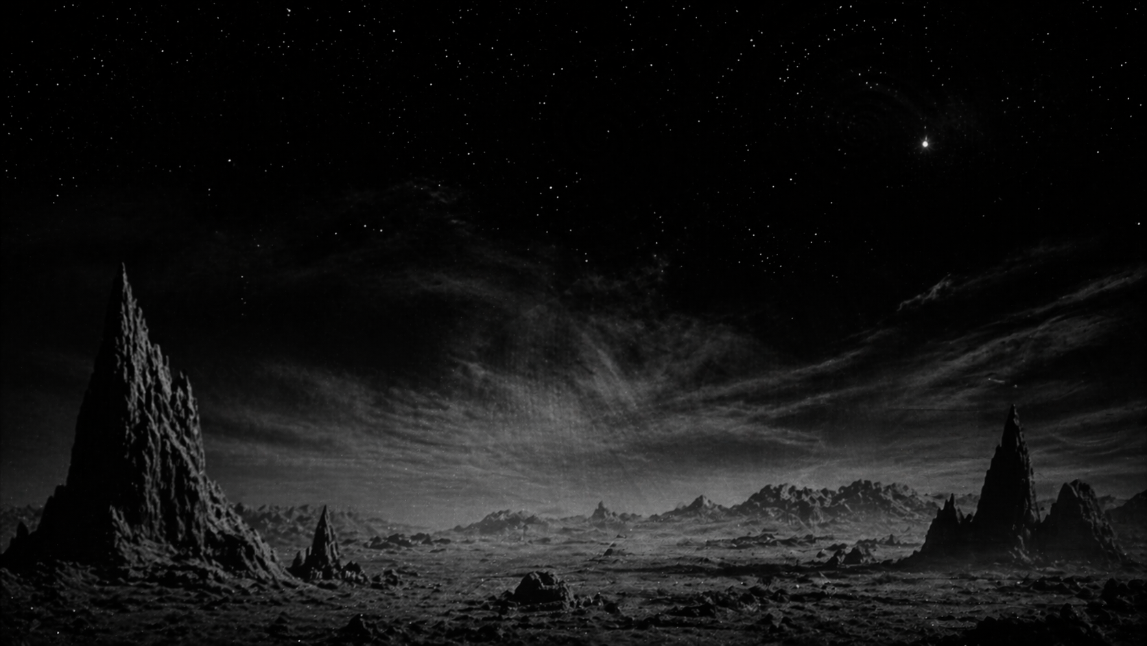 Black and white alien landscape under a star-filled sky