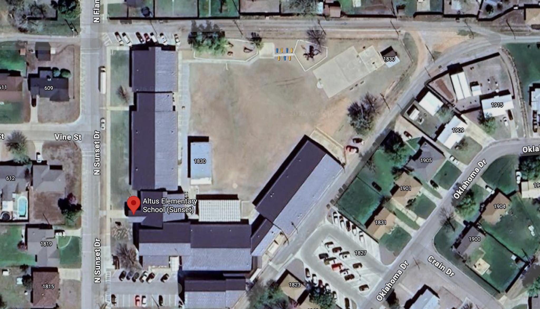 A satellite view of Sunset Elementary in Altus, Oklahoma, showing the school buildings and playground where childhood memories took shape.