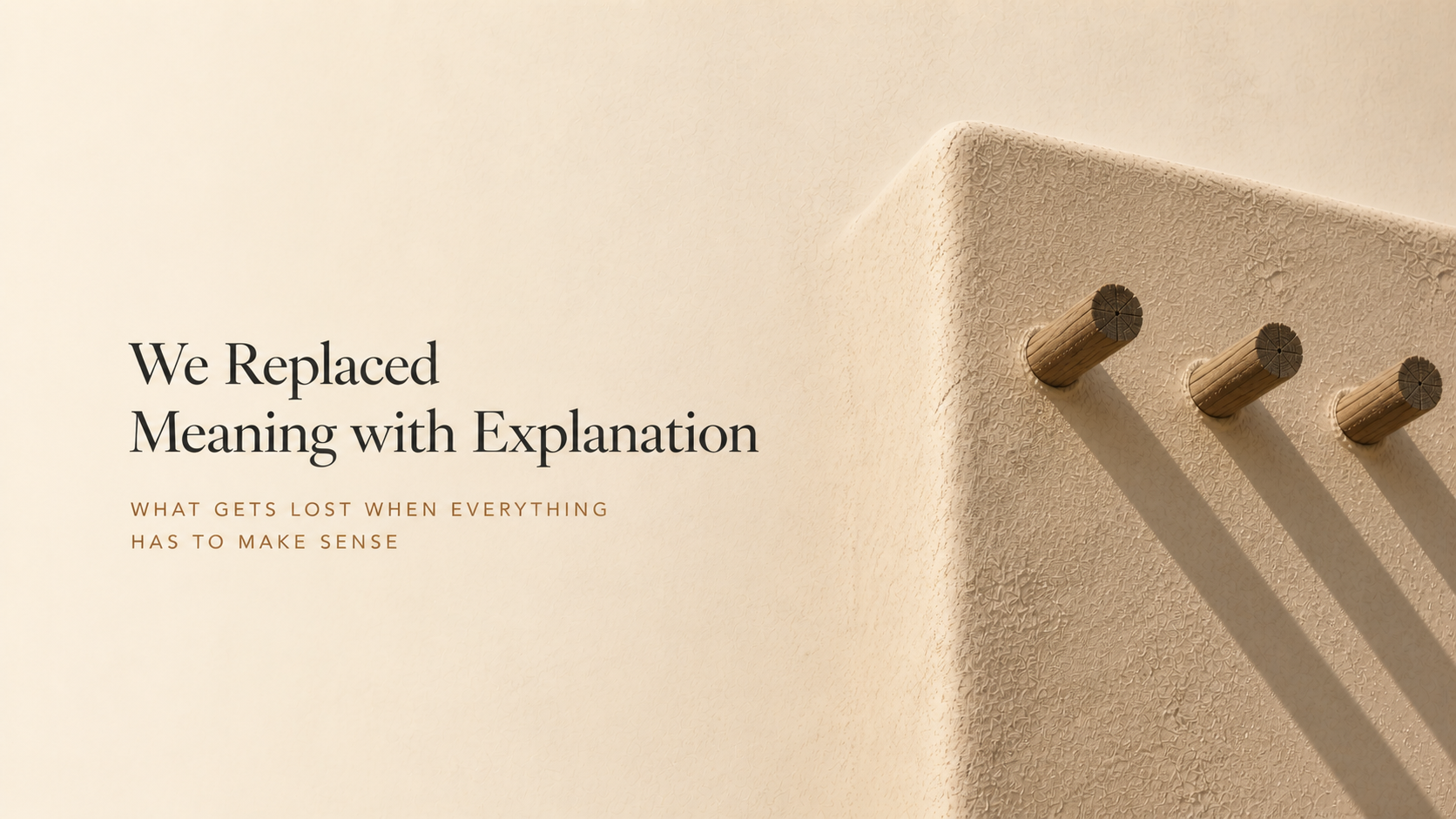 Adobe wall with three wooden vigas casting long shadows, fading into a soft neutral background